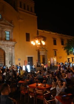 Cartagena, Colombia (March 2019): Lively crowd of unidentifiable tourists and locals with food and live music at central square near old cathedral of Cartagena